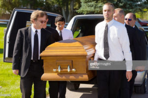 people holding coffin